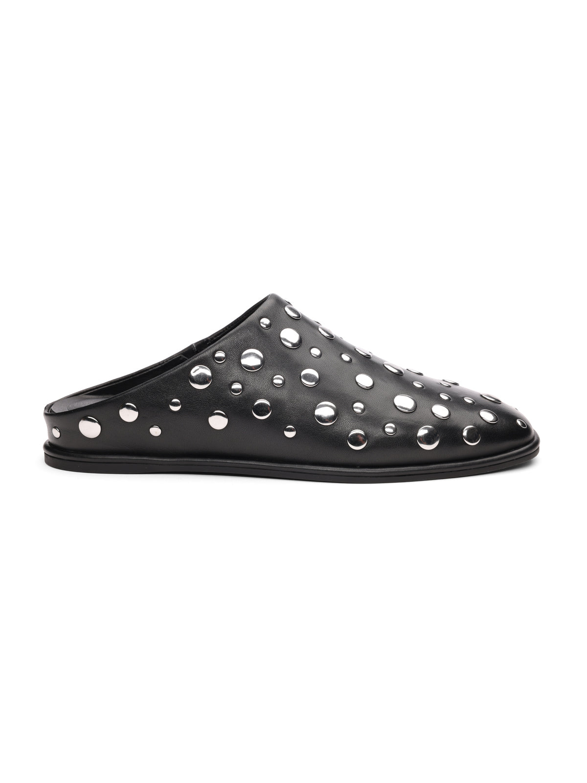 The bari studs mule black by Sanctuary Clothing is a black leather slip-on with a flat sole, featuring round silver studs of various sizes across the surface.