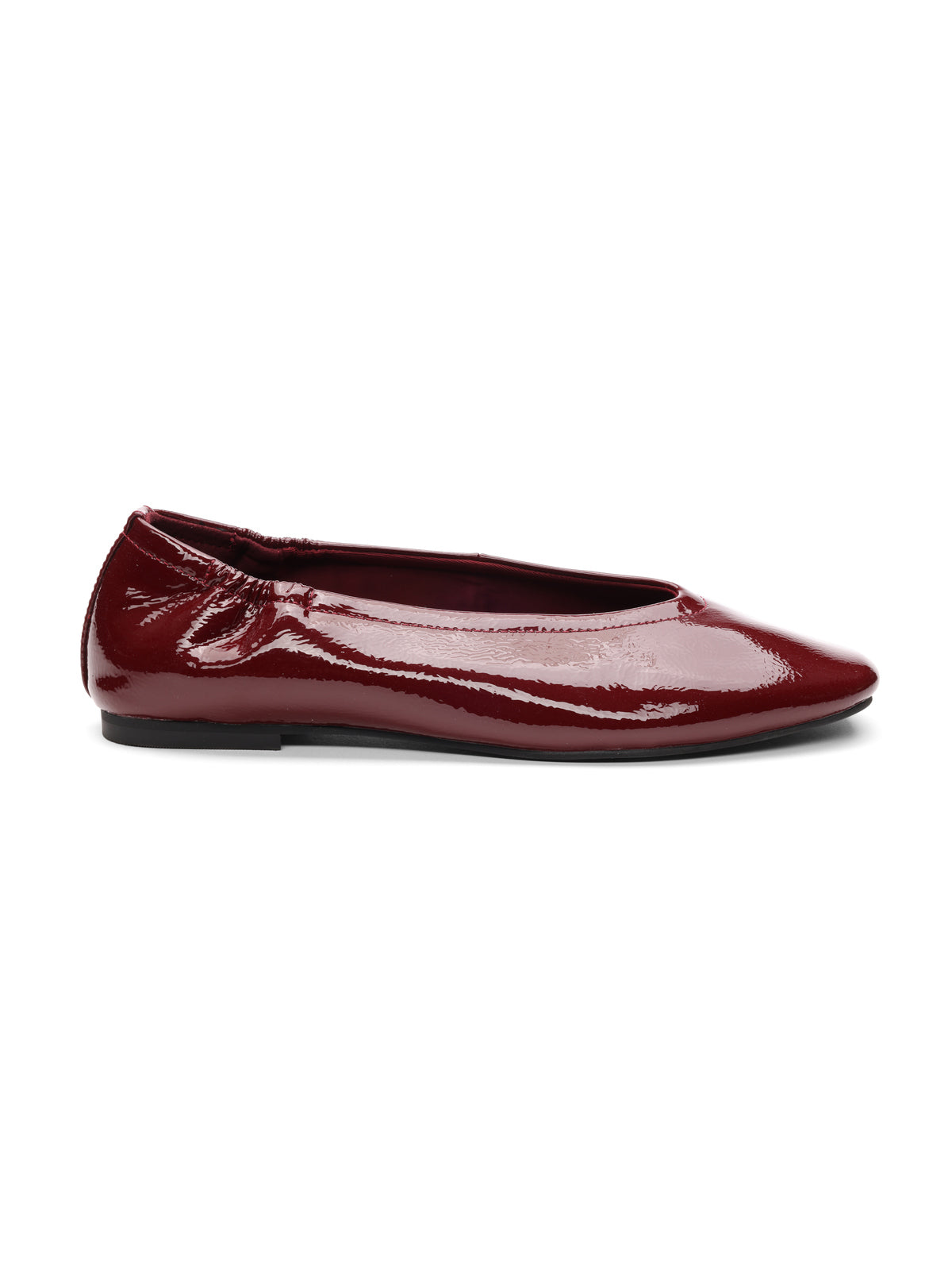 The gigi ballet flat by Sanctuary Clothing in black wine features shiny burgundy patent leather, a slightly ruched heel, and a slim black sole, displayed in side profile against a white background.