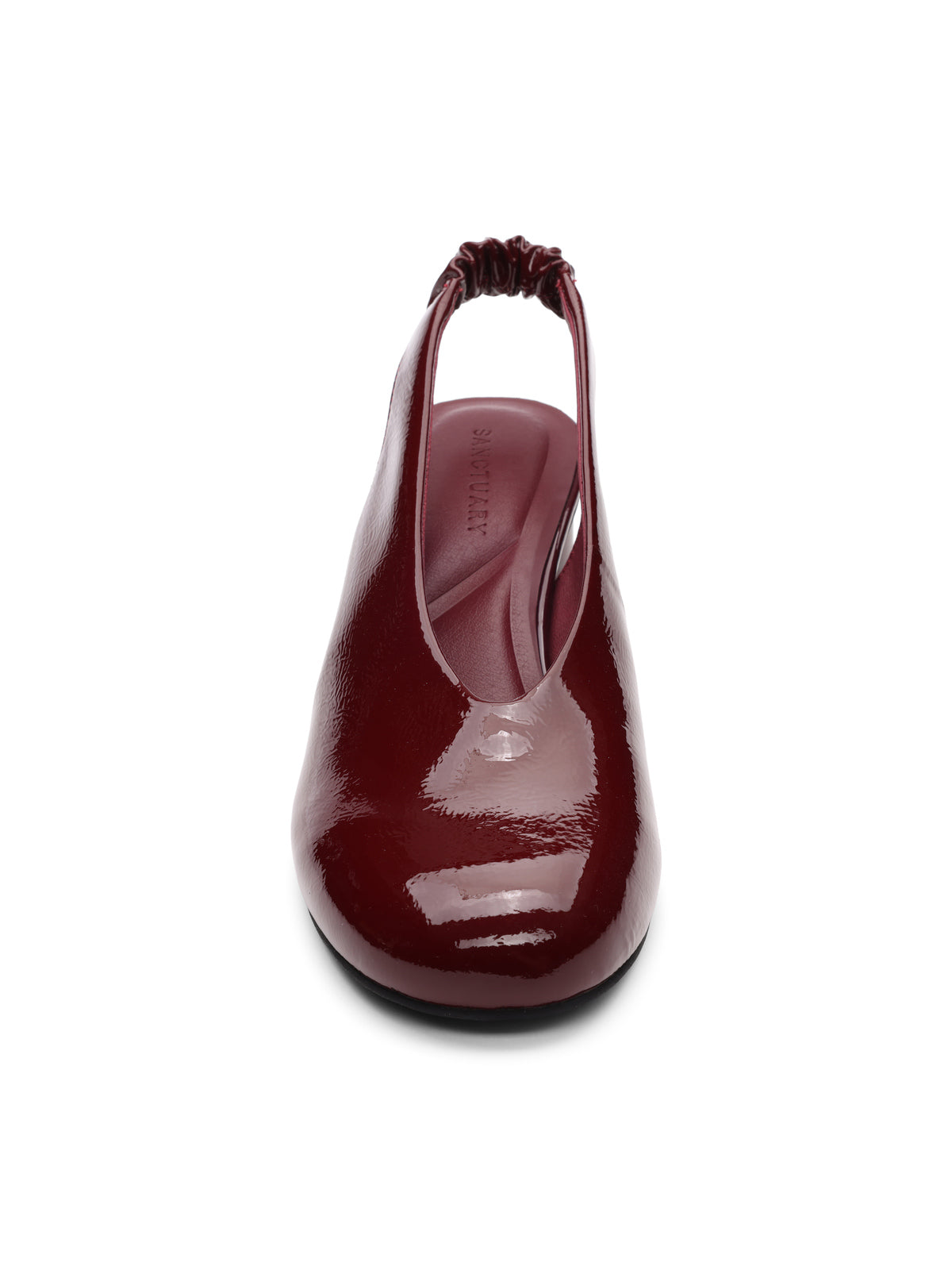 Front view of Sanctuary Clothing’s Opera Sling Back Pump in wine, featuring shiny patent leather, a closed toe, elastic back strap, and low-profile sole on a white background.